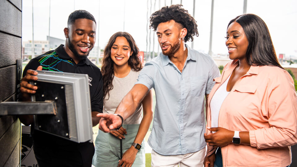 Guests choosing a game at Topgolf