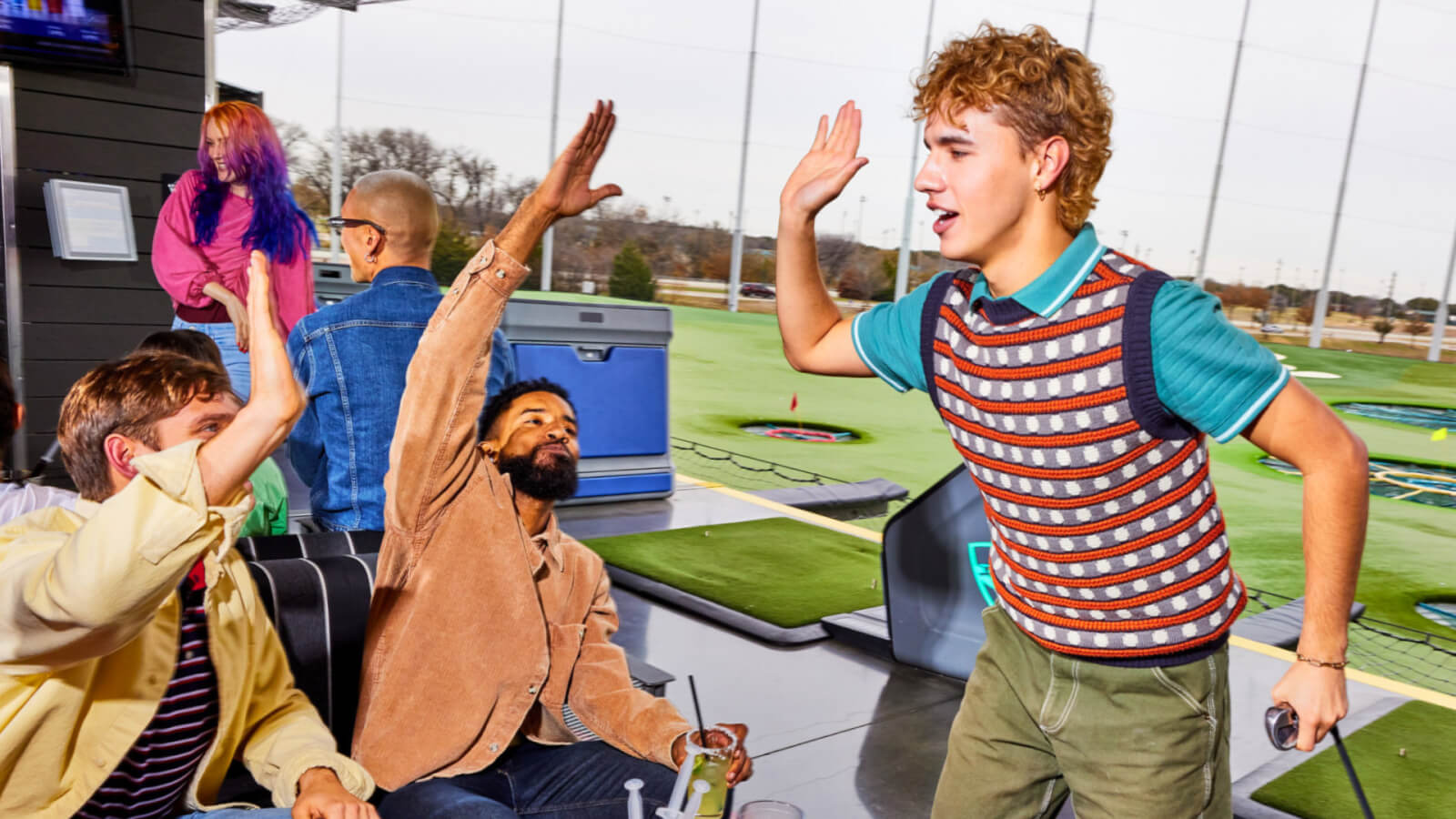 Groups playing and eating at Topgolf